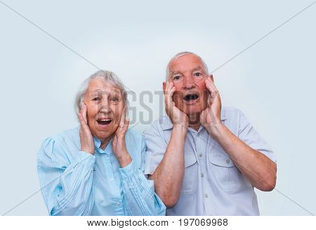 The elderly couple surprised by raising both hands at studio