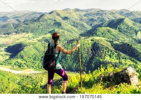 Hiking woman watching from top of the hill Hrdos (Ostre) and watching on beautiful summer landscape. Region Liptov Slovakia