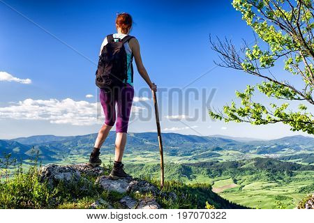 Hiking woman watching from top of the hill Hrdos (Ostre) and watching on beautiful summer landscape. Region Orava Slovakia