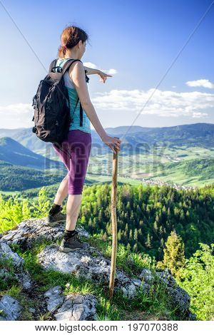 Hiking woman watching from top of the hill Hrdos (Ostre) and watching on beautiful summer landscape. Region Orava Slovakia