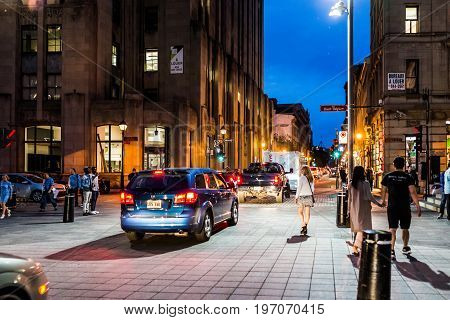Montreal, Canada - May 27, 2017: Old Town Area With People Crossing Saint Sulpice Street At Night In