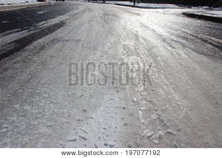 An icy sunlight road on a cold winter day.