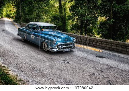 GOLA DEL FURLO, ITALY - MAY 19: OLDSMOBILE 88 1953 on an old racing car in rally Mille Miglia 2017 the famous italian historical race (1927-1957) on May 19 2017