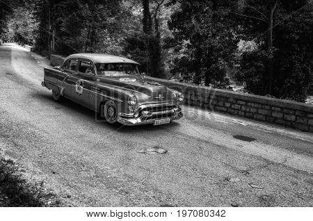 GOLA DEL FURLO, ITALY - MAY 19: OLDSMOBILE 88 1953 on an old racing car in rally Mille Miglia 2017 the famous italian historical race (1927-1957) on May 19 2017