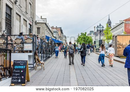 Montreal, Canada - May 27, 2017: Old Town Area With People Walking Up Street In Evening Outside Rest
