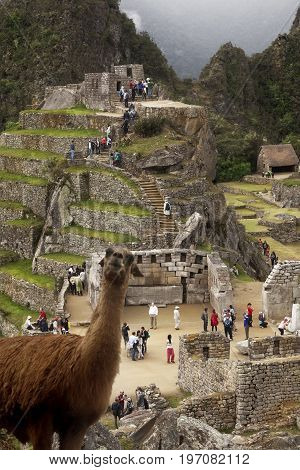 MACHUPICCHU, PERU-JUNE 4 2015: Spiritual morning mist rises over Inca head mountain at Machu Picchu with Huana Picchu in background on June 4, 2015