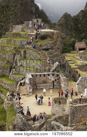 MACHUPICCHU, PERU: JUNE 4 2015: Spiritual morning mist rises over Inca head mountain at Machu Picchu with Huana Picchu in background on June 14, 2015