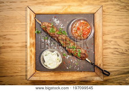 Lula kebab. Prepared from meat of black angus. Served with tomato salsa