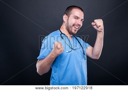 Doctor Wearing Scrubs With Stethoscope Making Happy Success Gesture