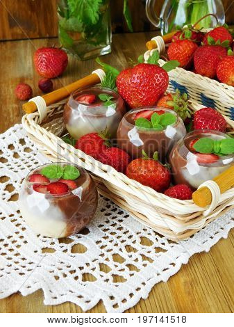 Chocolate sauce in little tasters and ripe strawberries