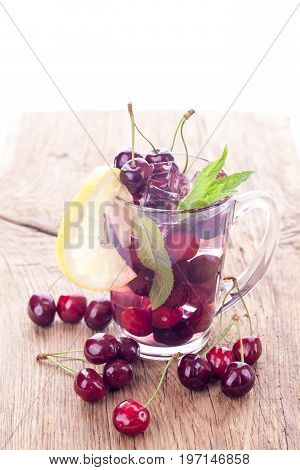 Ice cream and cherry juice on wooden background