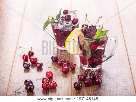 Ice cream and cherry juice on wooden background