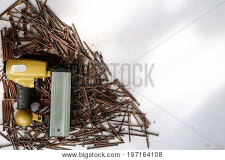 Air Nailer with rusty nail.Equipment for construction and industry.