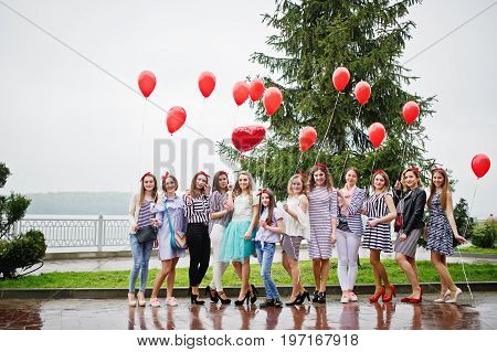 Eleven Amazingly-looking Braidsmaids With Stunning Bride Posing With Red Heart-shaped Balloons On Th