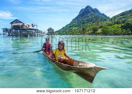 Semporna,Sabah,Malaysia-Apr 23,2017:Sea Gypsy kids on unique handmade boats surrounded by beautiful clear water of the Bodgaya island,Semporna,Sabah,Malaysia.