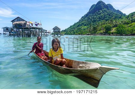 Semporna,Sabah,Malaysia-Apr 23,2017:Sea Gypsy kids on unique handmade boats surrounded by beautiful clear water of the Bodgaya island,Semporna,Sabah,Malaysia.