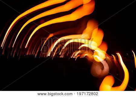 Red abstract trails of light on dark background. Long exposure.