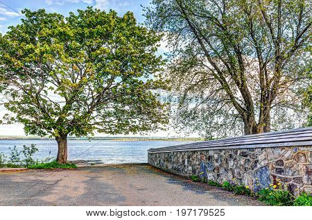 Landscape view of Saint Lawrence river from Ile D'Orleans Quebec Canada in summer with stone church wall