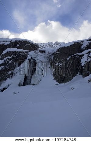 small waterfall in formazza valley during winter