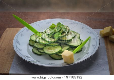 Fresh cucumber salad on a flat porcelain plate