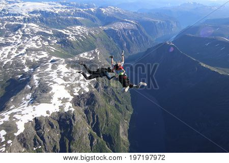 Skydiving over beautiful Norway. Clouds, sun and sky