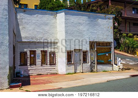 Abandoned Store Front Building With Boarded Up Windows