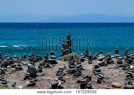 Cairn rock pebbles on Tenerife beach at Costa Adeje, Adeje, Tenerife Canary Islands, Spain