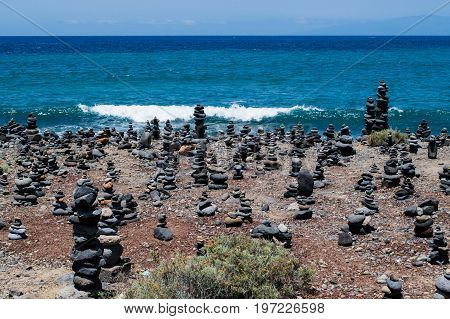 Cairn rock pebbles on Tenerife beach at Costa Adeje, Adeje, Tenerife Canary Islands, Spain