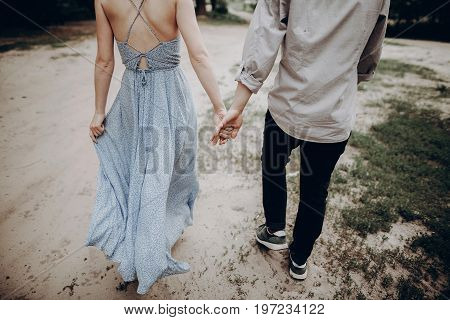 Stylish Hipster Couple Walking, Holding Hands. Man And Woman Embracing, In Love Relaxing In Summer P