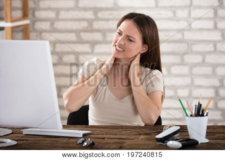 Businesswoman Suffering From Neck Ache Touching Her Neck In Pain