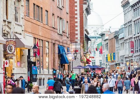 Montreal, Canada - May 27, 2017: Old Town Area With People Walking Up Street In Evening Outside Rest