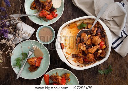 Dinner eating table with baked chicken breast with vegetables top view