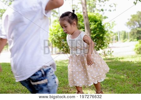 Happy child blowing soap bubbles in spring park with lens flares