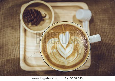 Coffee Latte Art Served On Wood Plate Decorated In Cafe Brown Color Tone Vintage Style.