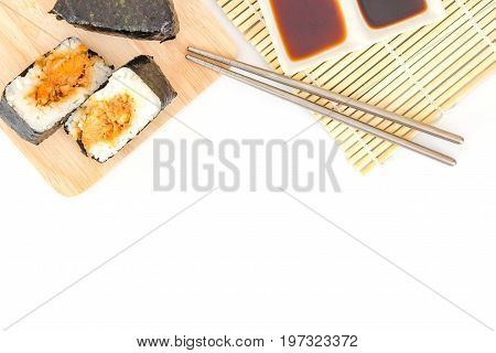 Japanese salmon rice wrapped in seaweed on wood plate isolated on white background with Copy space and text.