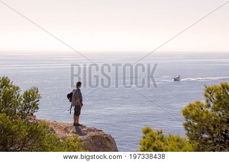 Men is looking at motor boat France marceille Massif des Calanques