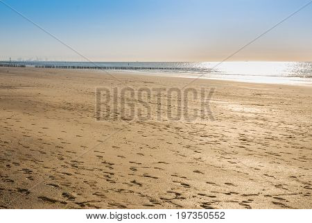 empty cadzand beach at the evening reflection from the sun on the water north sea netherlands