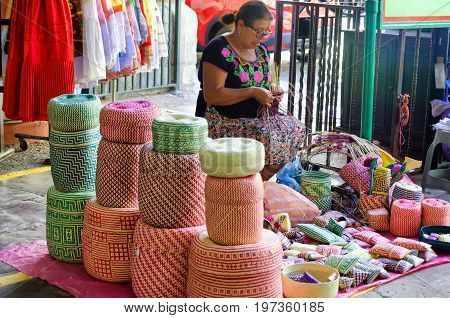 OAXACA MEXICO - MARCH 5: Woman makes traditional baskets for sale at local market in Oaxaca Mexico on March 5 2017