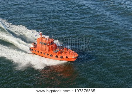 Helsinki, Finland-July 10, 2017: Pilot boat bringing pilot to the American Holland cruise ship Zuiderdam 