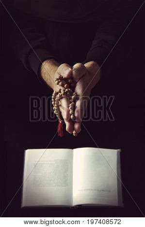 Hands Holding Rosary And Folded In Prayer