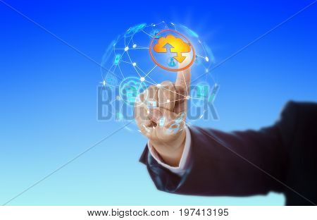 Hand of business man is activating a cloud computing icon in a globe shaped virtual computer network. IT concept for networking internet cloud storage wireless technology and global reach.