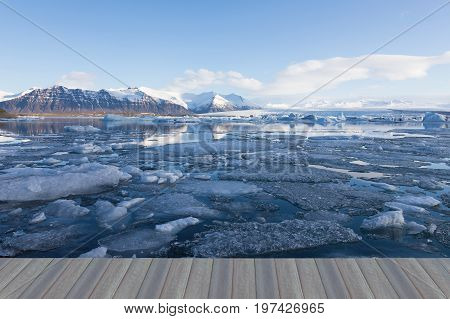 Opening wooden floor Jakulsarlon ice winter seasion lagoon with mountain and clear sky background Iceland natural landscape background