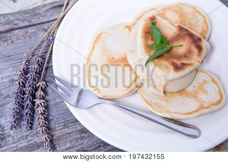 Pancakes with apples decorated with lavender and mint