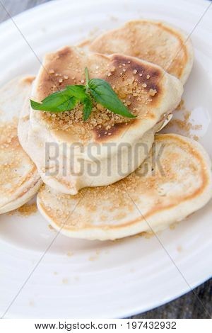 Pancakes With Apples Decorated With Mint And Brown Sugar