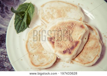 Pancakes with apples decorated with mint and brown sugar