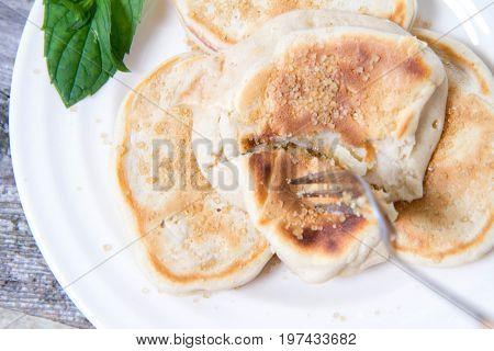 Pancakes With Apples Decorated With Mint And Brown Sugar