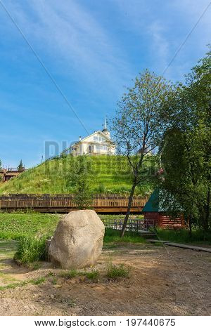 Sacred stone on the background of the church Radonezh font Golden Ring Russia