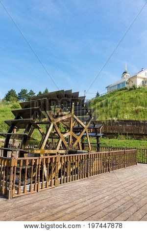 Water mill on the background of the church Radonezh Russia Golden Ring summer
