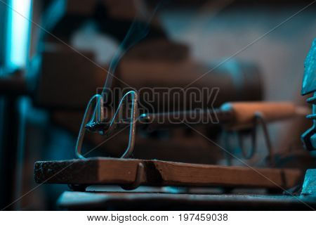 Old soldering iron in instrumental with blurred background