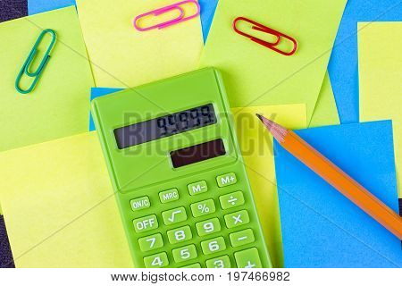 Multi colored pasted stickers and green calculator